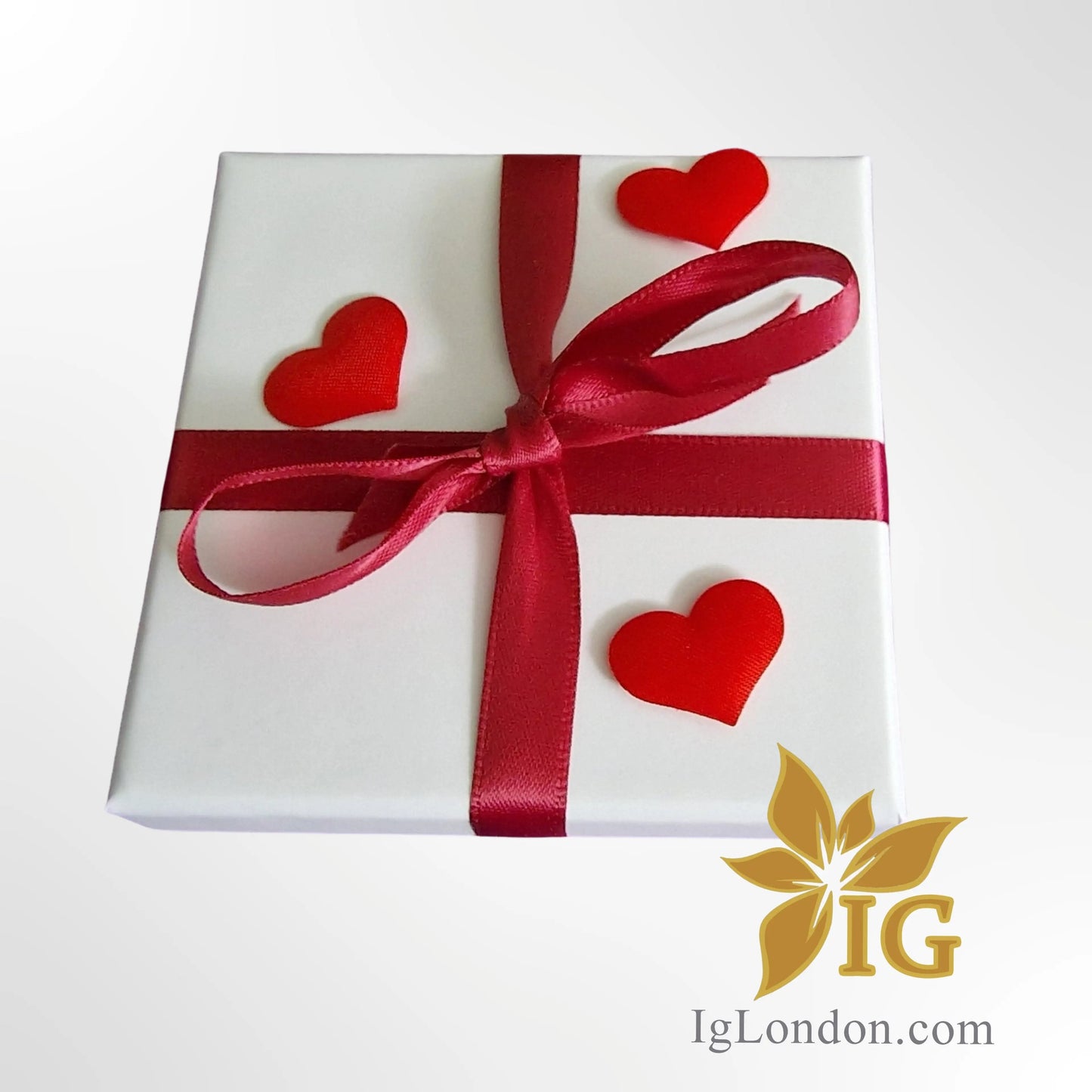 Gift box with red ribbon and hearts, suitable for presenting the Ball Bracelet Sterling Silver.