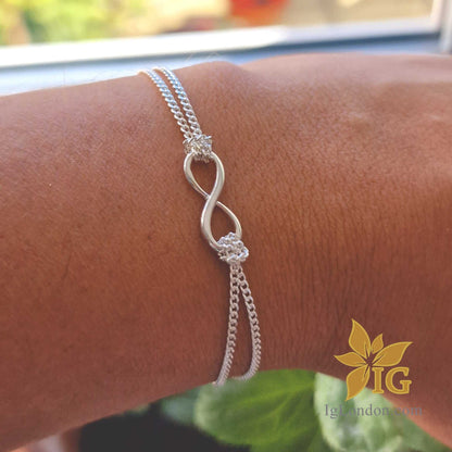 Sterling silver infinity bracelet with double layer curb chain.