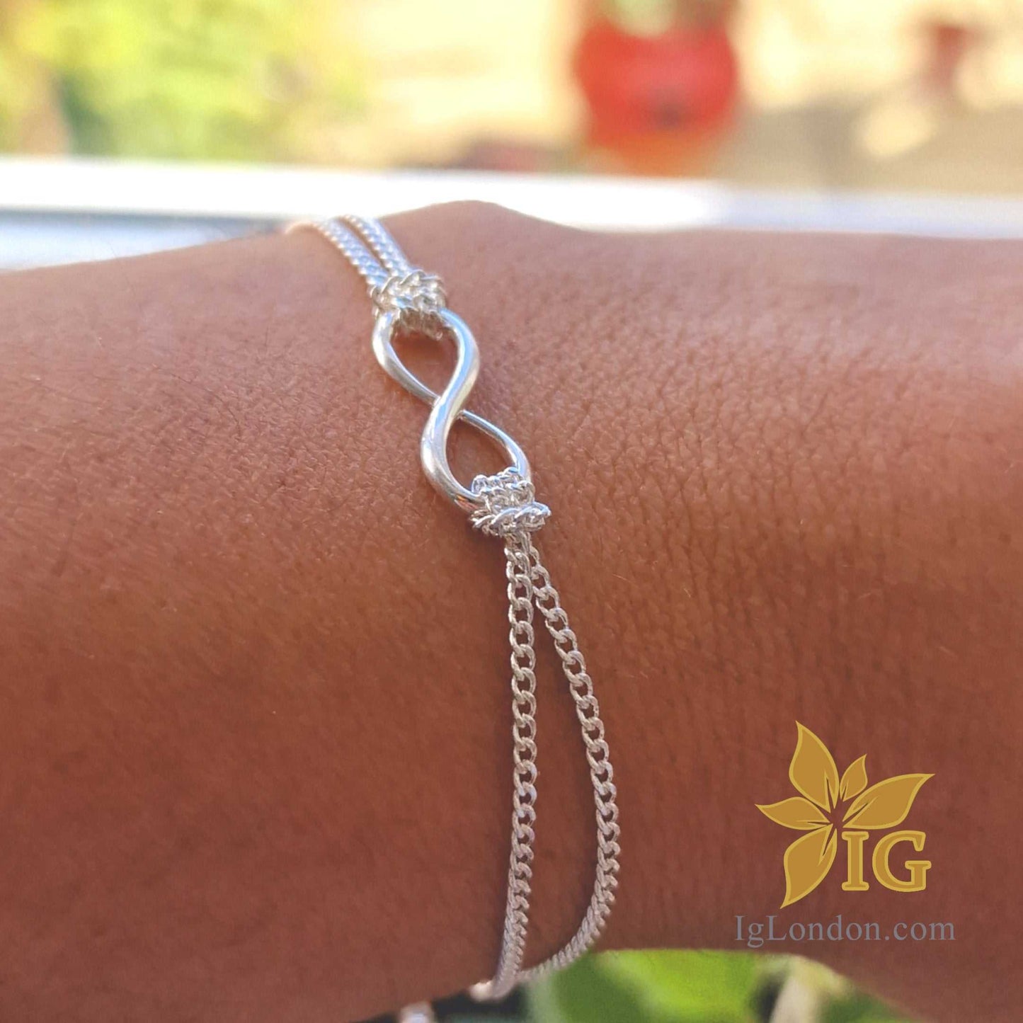 Sterling silver infinity bracelet with double layer chain.